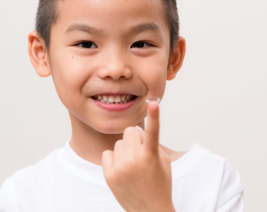 Little kid hold with a contact lens